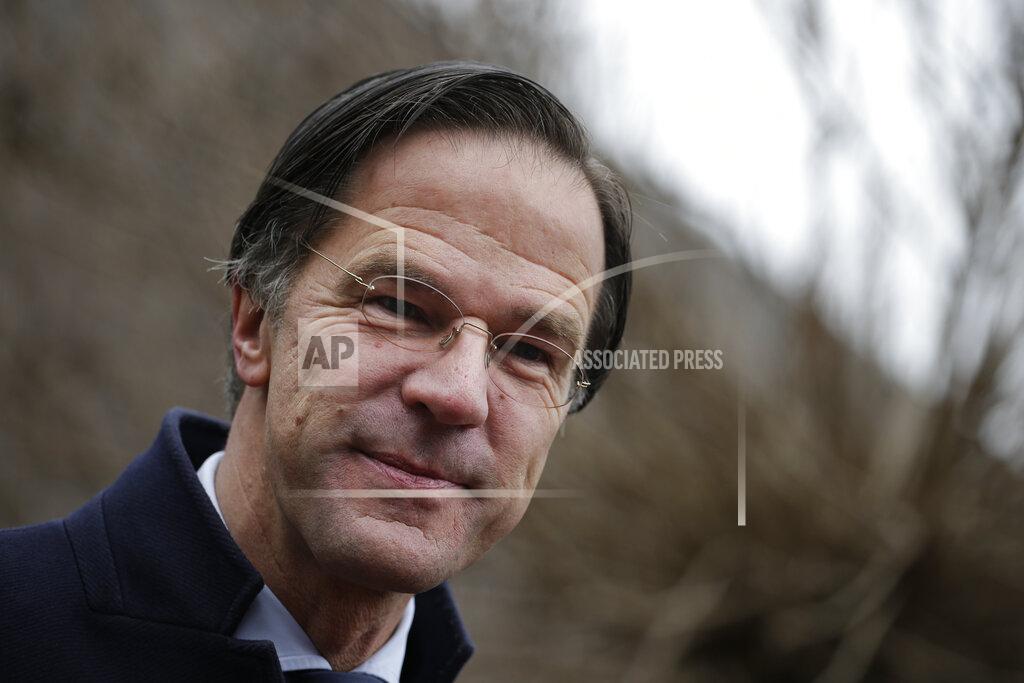 Peter Dejong Dutch caretaker Prime Minster Mark Rutte answers questions after casting his vote in a general election in The Hague, Wednesday, March 17, 2021. Polling stations have opened opened across the Netherlands from Monday in a general election that has been spread over three days to allow people to vote safely during the coronavirus pandemic. (AP Photo/Peter Dejong)