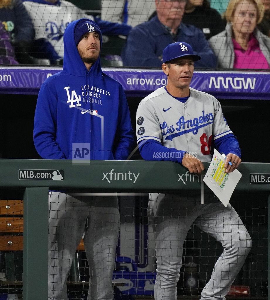 David Zalubowski Injured Los Angeles Dodgers center fielder Cody Bellinger, left, looks on with first base coach Clayton McCullough in the ninth inning of a baseball game against the Colorado Rockies Tuesday, Sept. 21, 2021, in Denver. (AP Photo/David Zalubowski)