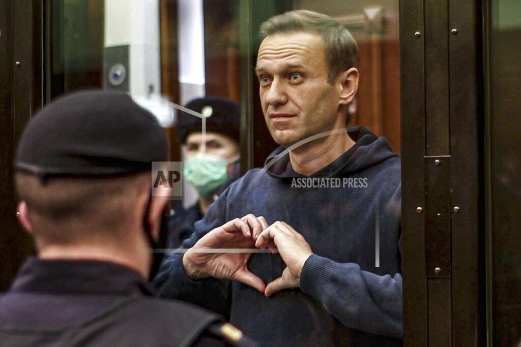 Uncredited FILE - In this photo taken from video provided by Moscow City Court on Tuesday, Feb. 2, 2021, Russian opposition leader Alexei Navalny forms a heart with his hands during a hearing on his prison sentence in the Moscow City Court in Moscow, Russia. Navalny is serving a 2½-year prison sentence for violating parole for a conviction he says was politically motivated. In the months before the Sept. 19 parliamentary election, authorities unleashed an unprecedented crackdown on the opposition, making sure that the best-known and loudest Kremlin critics didn’t run. (Moscow City Court via AP, File)