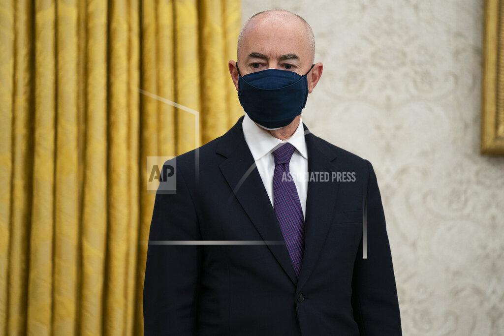 Evan Vucci Secretary of Homeland Security Alejandro Mayorkas looks on as President Joe Biden signs an executive order on immigration, in the Oval Office of the White House, Tuesday, Feb. 2, 2021, in Washington. (AP Photo/Evan Vucci)