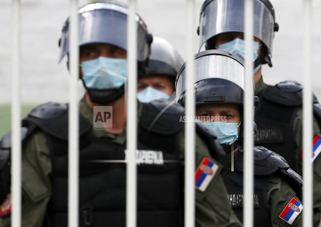 Darko Vojinovic FILE - In this Tuesday, June 2, 2020 file photo, Serbian police officers wearing protective face masks watch the Serbian Cup soccer match between FK Indjija and Red Star in Indjija, Serbia. Serbia's president Aleksandar Vucic has cancelled his party's pre-election rallies and officials in Bosnia, Macedonia and Albania are appealing on citizens to respect protection measures after relaxation of rules against the new coronavirus led to a recent spike in cases in the Balkan countries. (AP Photo/Darko Vojinovic, File)