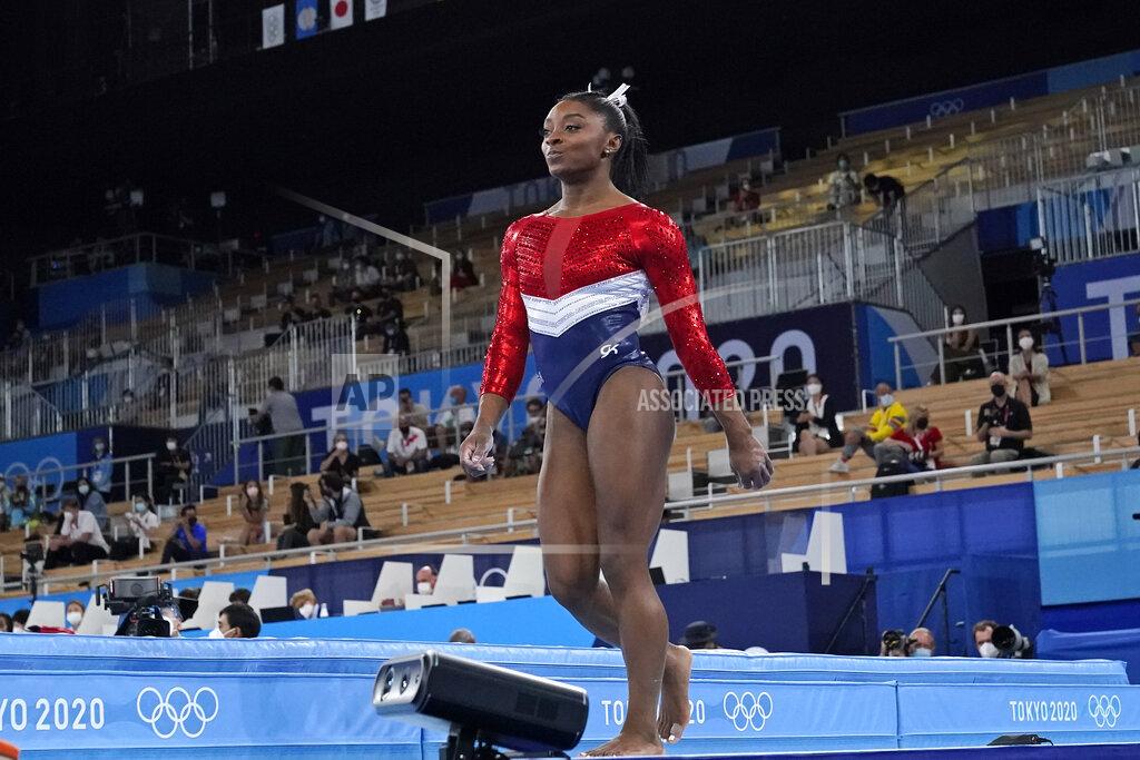 Simone Biles, of the United States, walks after performing on the vault during the artistic gymnastics women's final at the 2020 Summer Olympics, Tuesday, July 27, 2021, in Tokyo. (AP Photo/Ashley Landis)