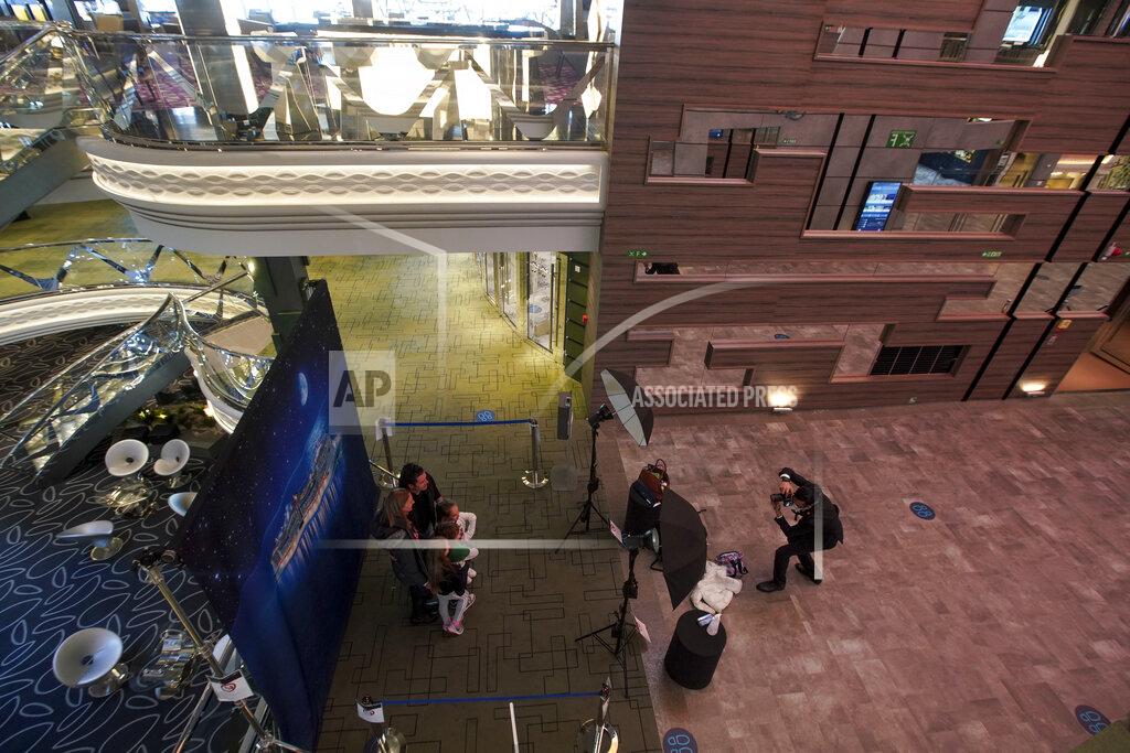 Andrew Medichini Passengers pose for a group photo as they board the MSC Grandiosa cruise ship in Civitavecchia, near Rome, Wednesday, March 31, 2021. MSC Grandiosa, the world's only cruise ship to be operating at the moment, left from Genoa on March 30 and stopped in Civitavecchia near Rome to pick up more passengers and then sail toward Naples, Cagliari, and Malta to be back in Genoa on April 6. For most of the winter, the MSC Grandiosa has been a lonely flag-bearer of the global cruise industry stalled by the pandemic, plying the Mediterranean Sea with seven-night cruises along Italy’s western coast, its major islands and a stop in Malta. (AP Photo/Andrew Medichini)