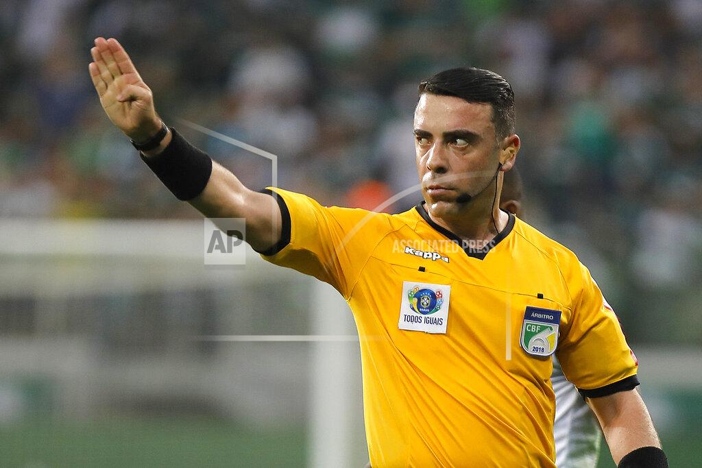 Brazilian referee Igor Benevenuto works during the Brazilian championship soccer game between Palmeiras and Bahia in Sao Paulo, Brazil, Nov.8, 2019. When the coronavirus pandemic forced Brazilian soccer to take a break, Benevenuto took one of the few jobs that were still in high demand in his countryside city of Sete Lagoas, as a nurse at a public hospital filled with COVID-19 patients. (Daniel Vorley/AGIF via AP)