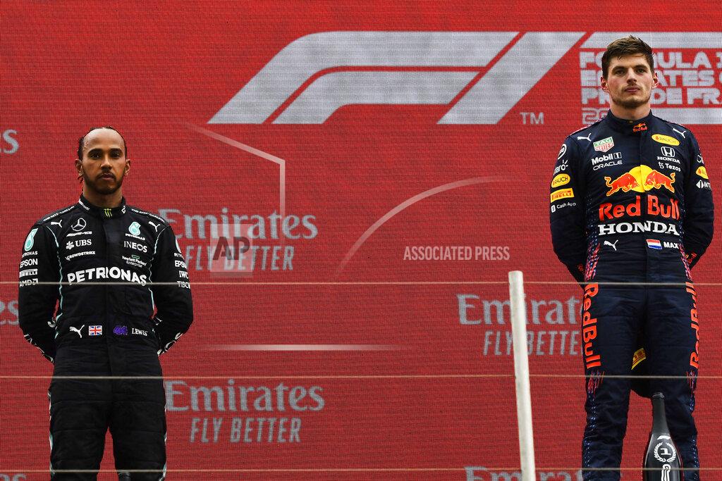 Red Bull driver Max Verstappen of the Netherlands, right, celebrates from the podium after winning the French Formula One Grand Prix next to second place Mercedes driver Lewis Hamilton of Britain, left, at the Paul Ricard racetrack in Le Castellet, southern France, Sunday, June 20, 2021. (Nicolas Tucat/Pool via AP)