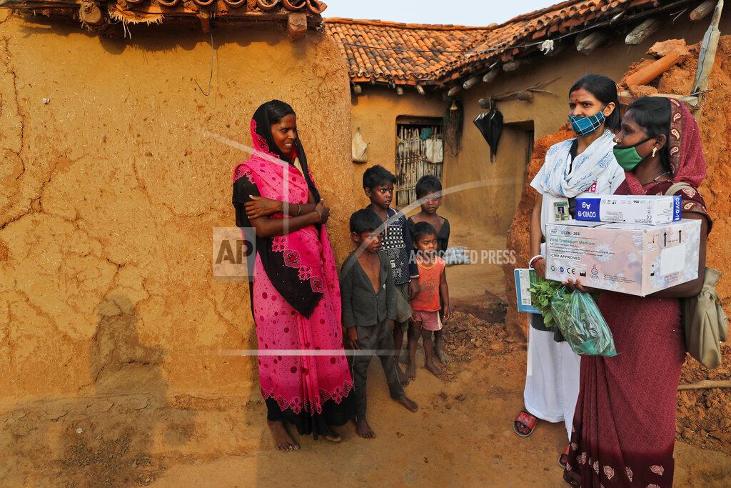 Rajesh Kumar Singh A health worker, right, persuades village woman Maju Kol, left, to get vaccinated against the coronavirus at Jamsoti village, Uttar Pradesh state, India, on June 8, 2021. India's vaccination efforts are being undermined by widespread hesitancy and fear of the jabs, fueled by misinformation and mistrust. That's especially true in rural India, where two-thirds of the country’s nearly 1.4 billion people live. (AP Photo/Rajesh Kumar Singh)