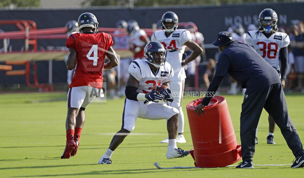FILE - In this Thursday, Aug. 15, 2019 file photo, Houston Texans running back Karan Higdon (31) carries the ball during a joint NFL training camp football practice with the Detroit Lions in Houston. The NFL still plans to hold training camps on time beginning in late July, though contingency plans are in place. Hours after the league canceled the Hall of Fame game that kicks off the preseason, the 32 team owners on Thursday, June 25, 2020 were updated on a variety of issues, many dealing with working through the coronavirus pandemic. (AP Photo/David J. Phillip, File)
