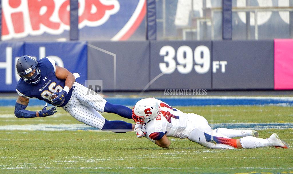 Howard Simmons Syracuse linebacker Ryan Guthrie (41) tackles Notre Dame tight end Alize Mack (86)during the first half of an NCAA college football game, Saturday, Nov. 17, 2018, at Yankee Stadium in New York. (AP Photo/Howard Simmons)