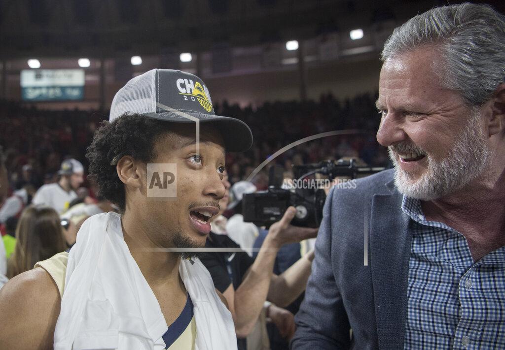 Lee Luther Jr. Liberty guard Darius McGhee, left, talks with Liberty University President Jerry Falwell Jr. after defeating Lipscomb in the Atlantic Sun Conference NCAA basketball championship game in Lynchburg, Va., Sunday, March 8, 2020. (AP Photo/Lee Luther Jr.)