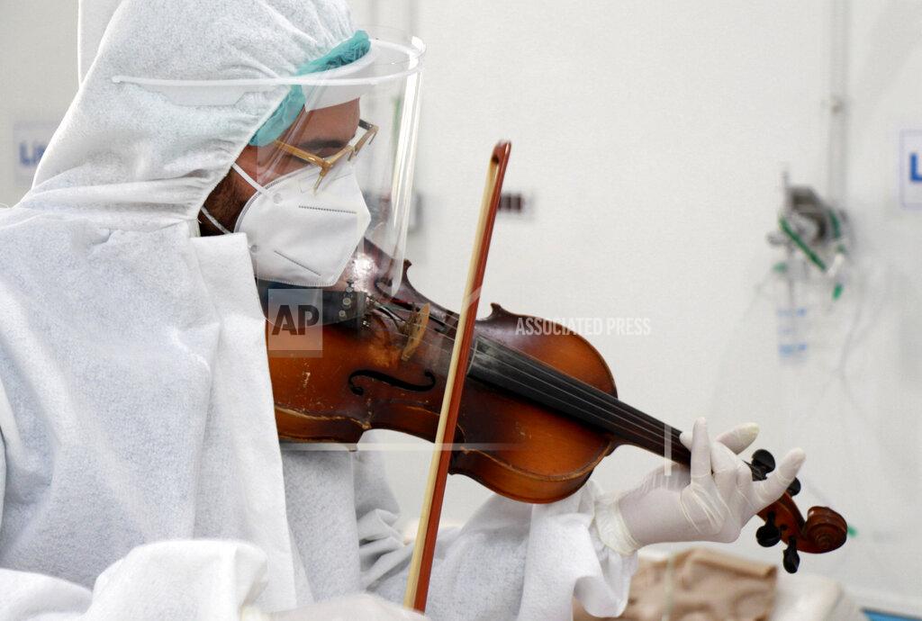 Uncredited HOLD FOR STORY SLUGGED TUNISIA VIRUS OUTBREAK - Dr. Mohamed Salah Siala plays violin for patients of the COVID wards of the Hedi Chaker hospital in Sfax, eastern Tunisia. (AP Photo/str)