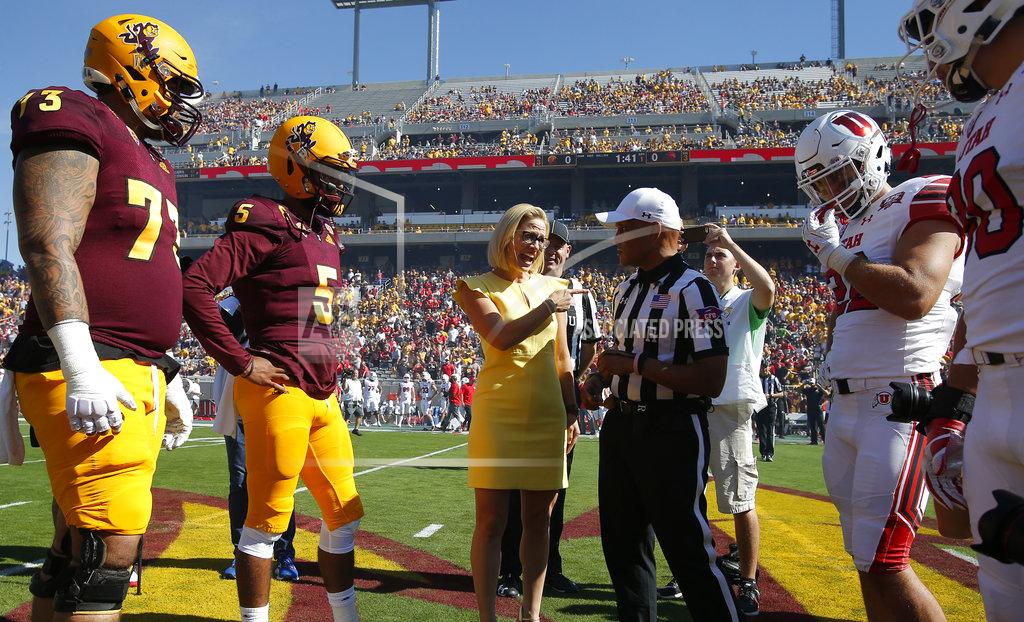 Rick Scuteri Democratic U.S. Senate candidate Kyrsten Sinema talks with the referee during the coin toss before an NCAA college football game between Arizona State and Utah, Saturday, Nov 3, 2018, in Tempe, Ariz. (AP Photo/Rick Scuteri)