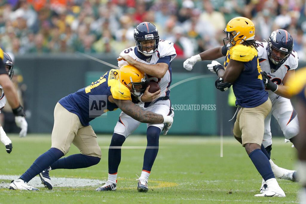 Matt Ludtke Denver Broncos quarterback Joe Flacco, center, is hit by Green Bay Packers outside linebacker Preston Smith, left, as Packers' linebacker Rashan Gary, right, watches during the first half of an NFL football game Sunday, Sept. 22, 2019, in Green Bay, Wis. (AP Photo/Matt Ludtke)