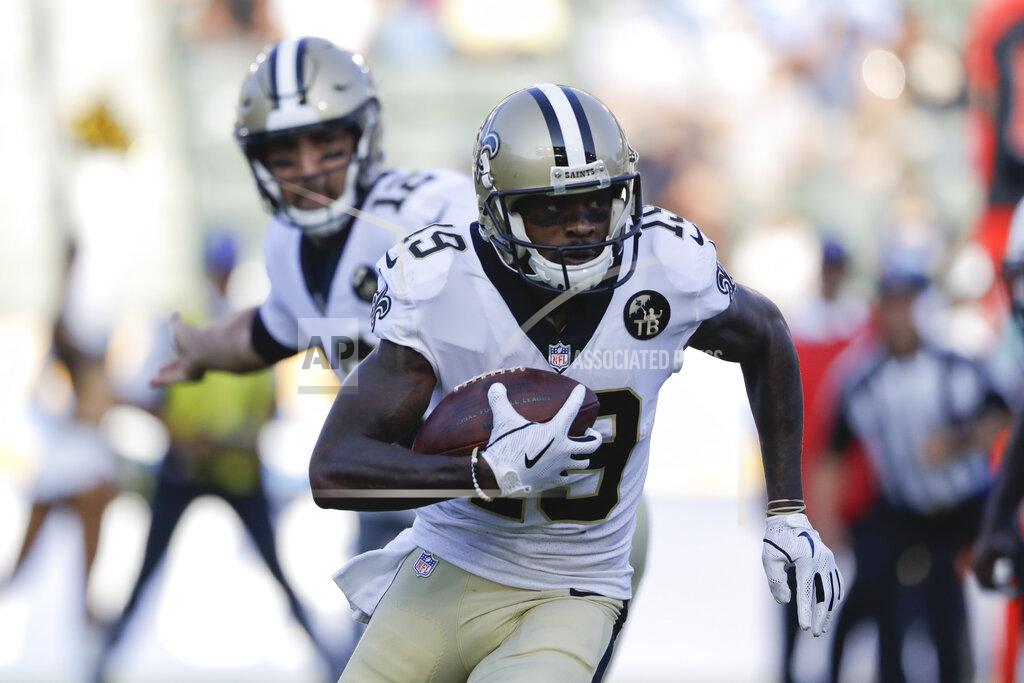 FILE - In this Saturday, Aug. 25, 2018 file photo, New Orleans Saints wide receiver Ted Ginn runs with the ball during the first half of an NFL preseason football game against the Los Angeles Chargers in Carson, Calif. Saints receiver Ted Ginn Jr. says speed remains his most distinguishing asset as he enters his 13th NFL season. The 34-year-old former Ohio State star says he worried knee problems that wiped out much of last season might force his retirement. But now he says he’s confident he remains among football’s fastest after offseason workouts emphasizing agility and flexibility and a change in diet. (AP Photo/Marcio Jose Sanchez, File)