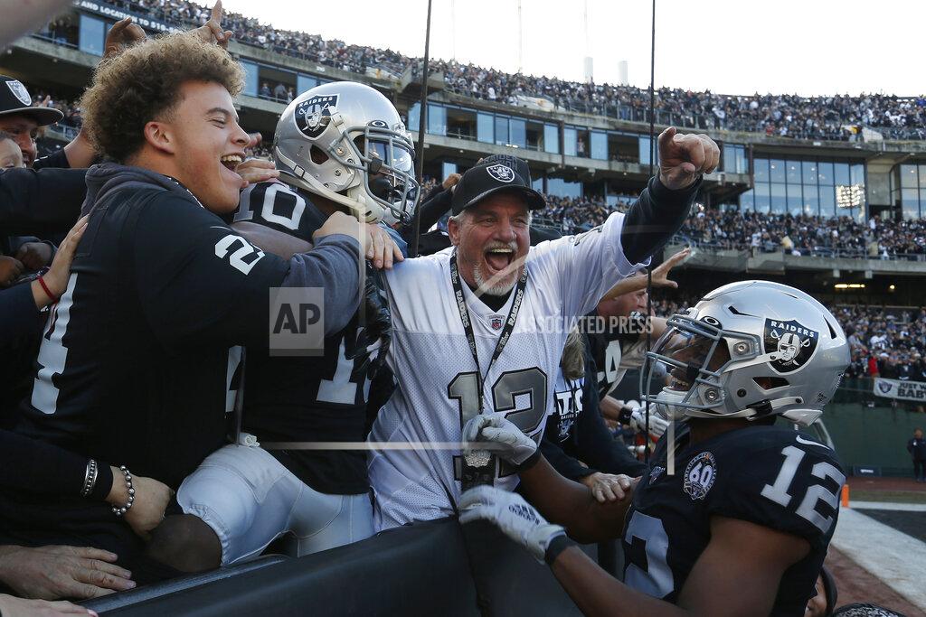 D. Ross Cameron Oakland Raiders wide receiver Rico Gafford (10) celebrates with fans and wide receiver Zay Jones (12) after scoring against the Tennessee Titans during the first half of an NFL football game in Oakland, Calif., Sunday, Dec. 8, 2019. (AP Photo/D. Ross Cameron)