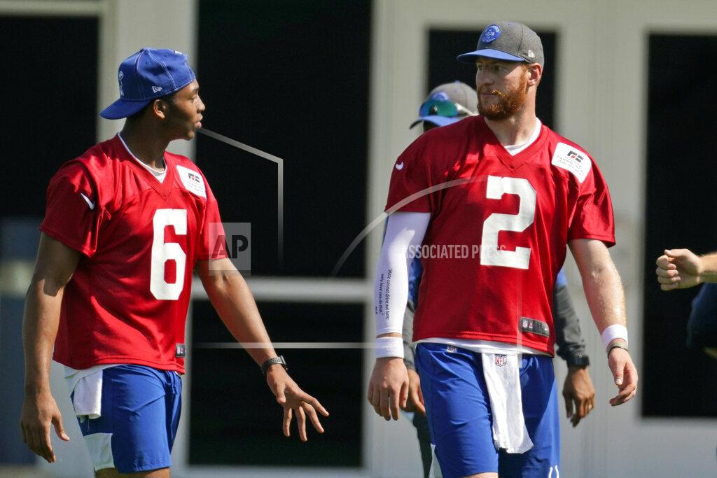 Darron Cummings Indianapolis Colts quarterback Carson Wentz (2) talks with quarterback Jalen Morton (6) runs a drill during NFL football practice, Thursday, May 20, 2021, in Indianapolis. (AP Photo/Darron Cummings)
