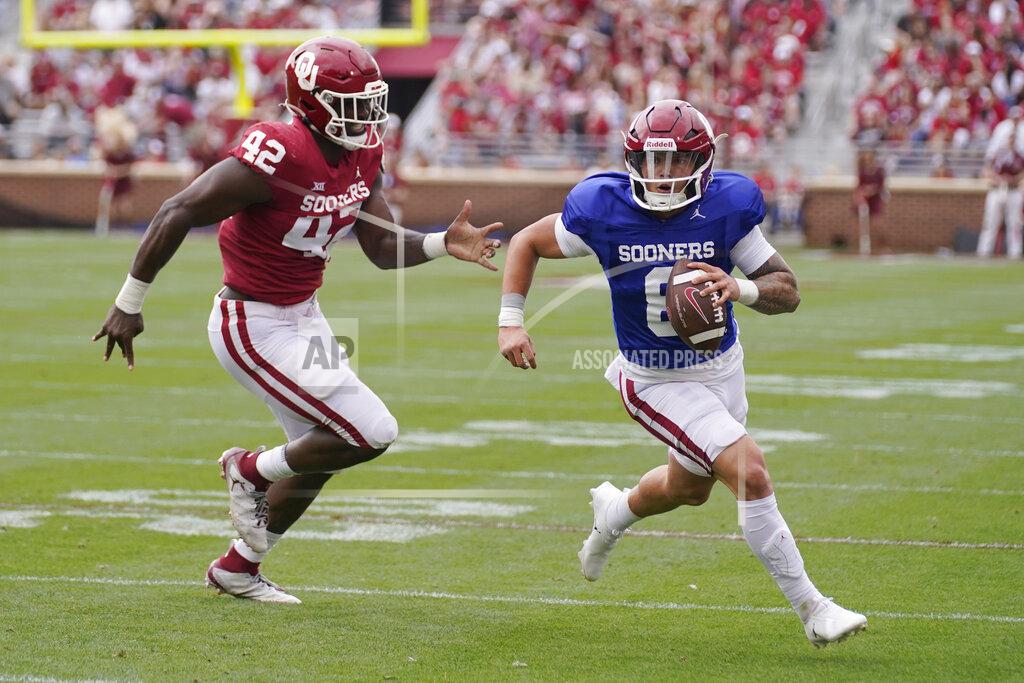 Sue Ogrocki Oklahoma quarterback Dillon Gabriel (8) carries past Noah Arinze (42) during the school's NCAA college spring football game, Saturday, April 23, 2022, in Norman, Okla. (AP Photo/Sue Ogrocki)