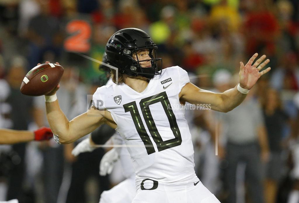 Rick Scuteri FILE - In this Oct. 27, 2018, file photo, Oregon quarterback Justin Herbert (10) throws during an NCAA college football game against Arizona, in Tucson, Ariz. Herbert is one of the league's better passers. Herbert has thrown for 2,333 yards and 22 touchdowns while completing 59 percent of his passes. The junior lit up the Utah Utes two years ago in a 30-28 win for Oregon in Salt Lake City, throwing for 324 yards and three touchdowns. (AP Photo/Rick Scuteri, File)