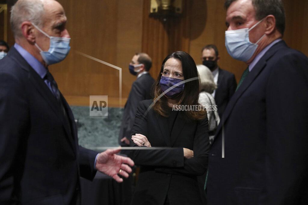 Joe Raedle Former Director of National Intelligence Daniel Coats, left, President-elect Joe Biden’s pick for national intelligence director Avril Haines, center, and Sen. Mark Warner, D-Va., talk before a confirmation hearing for Haines before the Senate intelligence committee on Tuesday, Jan. 19, 2021, in Washington. (Joe Raedle/Pool via AP)