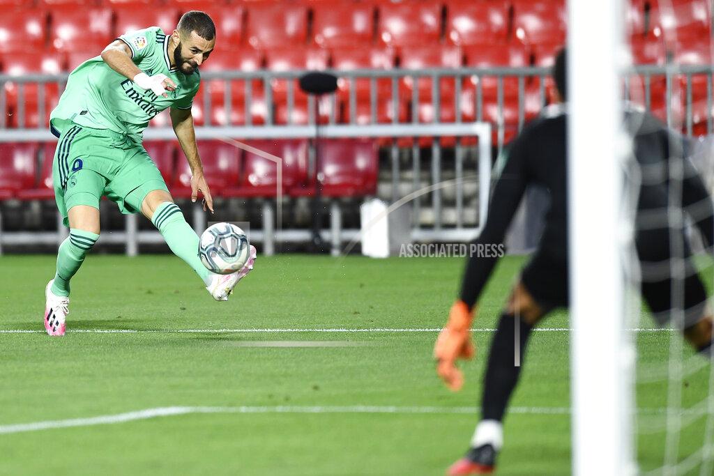 Jose Breton Real Madrid's Karim Benzema kicks the ball during the Spanish La Liga soccer match between Granada and Real Madrid at the Los Carmenes stadium in Granada, Spain, Monday, July 13, 2020. (AP Photo/Jose Breton)