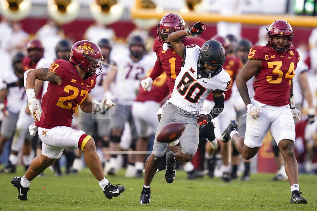 Charlie Neibergall Oklahoma State wide receiver Brennan Presley (80) tries to catch a pass between Iowa State defenders Craig McDonald (27) and O'Rien Vance (34) during the second half of an NCAA college football game, Saturday, Oct. 23, 2021, in Ames, Iowa. The pass was incomplete. Iowa State won 24-21. (AP Photo/Charlie Neibergall)