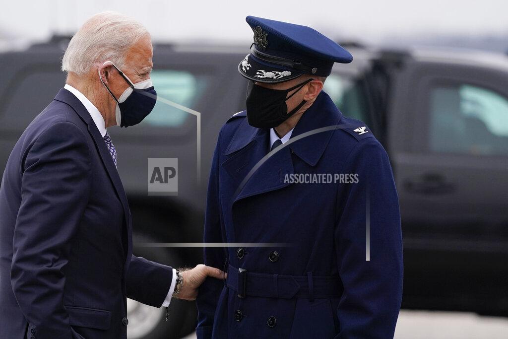 Evan Vucci President Joe Biden speaks to someone as he arrives to board Air Force One for a trip to Kalamazoo, Mich., to visit a Pfizer plant, Friday, Feb. 19, 2021, in Andrews Air Force Base, Md. (AP Photo/Evan Vucci)