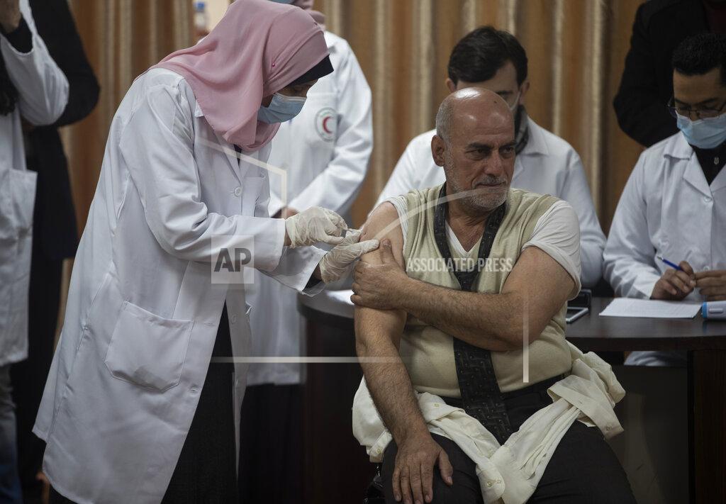 Khalil Hamra Former Palestinian Health Minister Jawad al-Tibi receives a shot of the COVID-19 Russian-made Sputnik V vaccine, in Gaza City, Monday, Feb. 22, 2021. (AP Photo/Khalil Hamra)