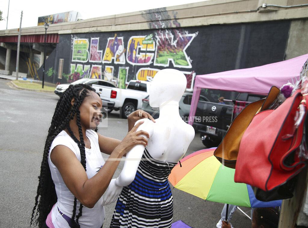 Matt Barnard Demetria Jackson, from Kansas City, Kan,, sets out merchandise ahead of a Juneteenth celebration in the Greenwood District in Tulsa, Okla., on Friday, June 19, 2020. Friday marks Juneteenth, the day in 1865 when federal troops arrived in Galveston, Texas, to take control of the state and ensure all enslaved people be freed more than two years after the Emancipation Proclamation. (Matt Barnard/Tulsa World via AP)