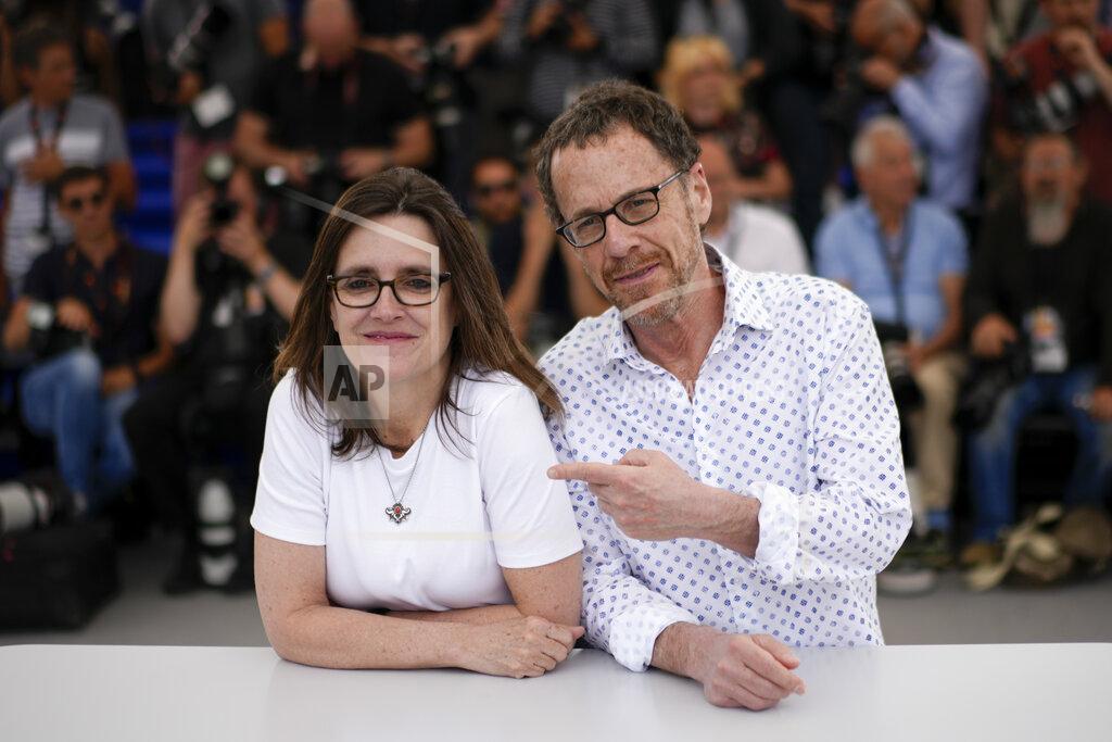 Daniel Cole Tricia Cooke, left, and director Ethan Coen pose for photographers at the photo call for the film 'Jerry Lee Lewis: Trouble in Mind' at the 75th international film festival, Cannes, southern France, Monday, May 23, 2022. (AP Photo/Daniel Cole)
