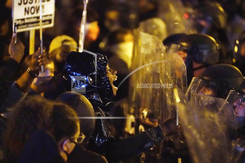 Matt Slocum FILE — In this Oct. 27, 2020 file photo, protesters confront police during a march, in Philadelphia, over the death of Walter Wallace, a Black man who was killed by police in Philadelphia.(AP Photo/Matt Slocum, File)