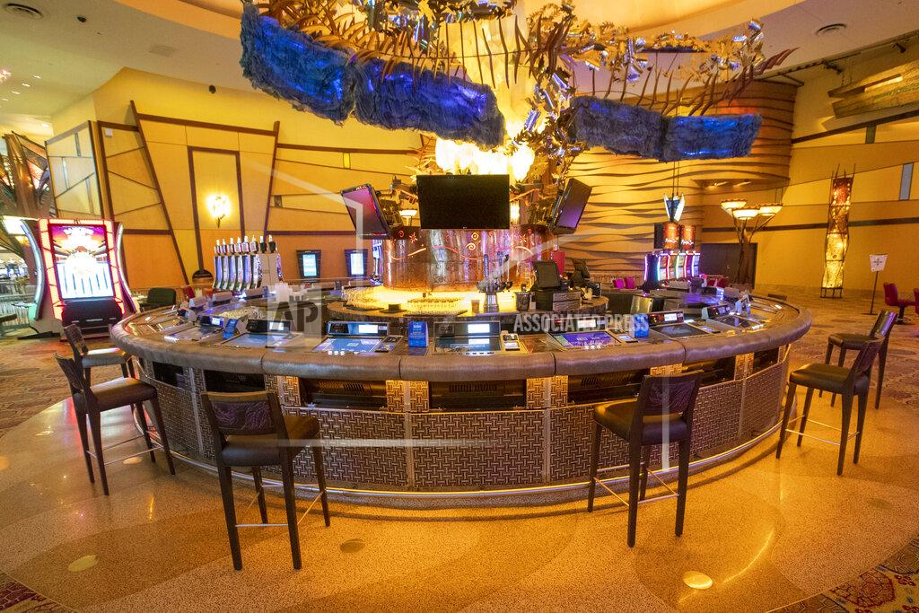 Stools are placed to maintain proper social distancing as guest play video poker at a bar at the Mohegan Sun casino, Thursday, May 21, 2020, in Uncasville, Conn. Connecticut's two federally recognized tribes, Mashantucket Pequot and Mohegan tribes, said they're planning to reopen parts of their southeastern Connecticut casinos on June 1, despite Gov. Ned Lamont saying it's too early and dangerous. (AP Photo/Mary Altaffer)