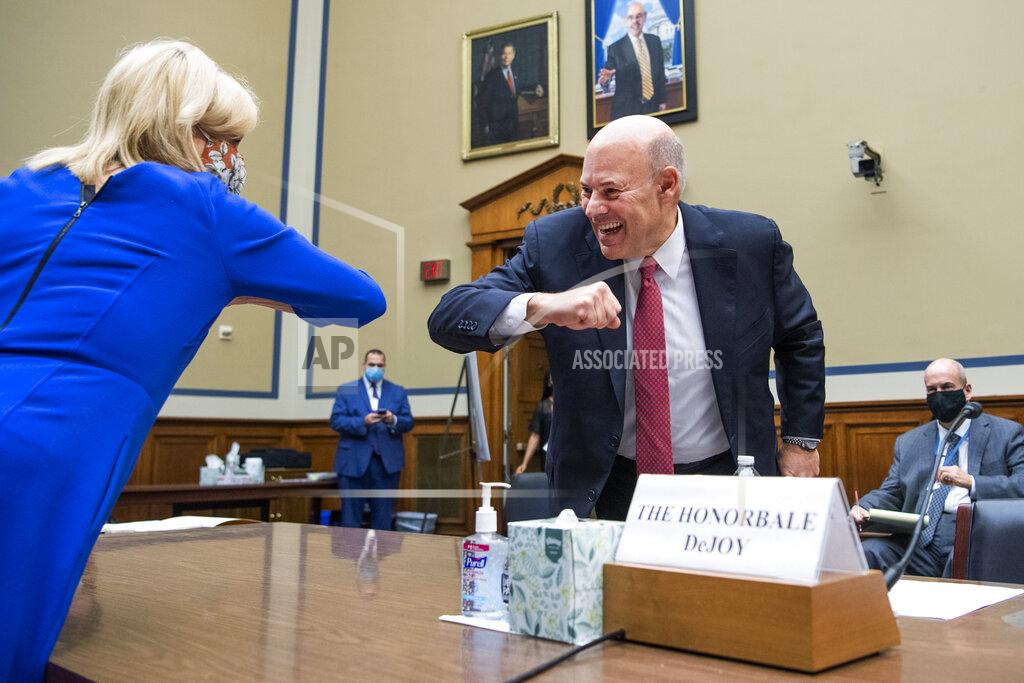 Tom Williams Postmaster General Louis DeJoy elbow bumps with Rep. Carolyn Maloney, D-N.Y., the chair of the Oversight Committee, before a House Oversight and Reform Committee hearing on the Postal Service on Capitol Hill, Monday, Aug. 24, 2020, in Washington. (Tom Williams/Pool via AP)