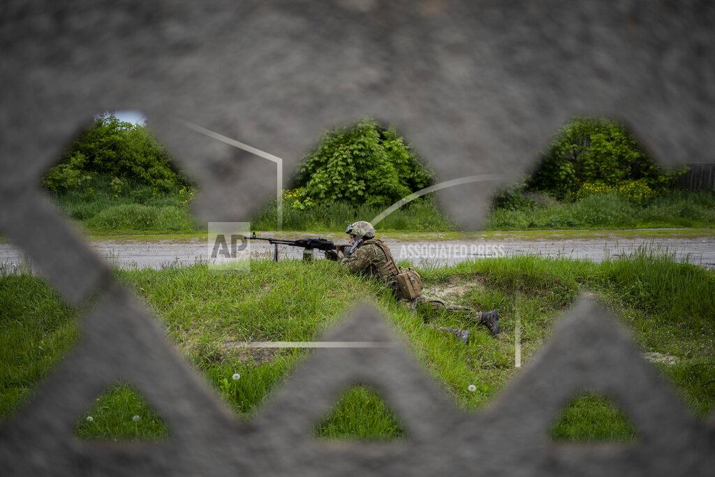 Bernat Armangue A Ukrainian National Guard soldier guards a position during a reconnaissance mission in a recently retaken village on the outskirts of Kharkiv, east Ukraine, Saturday, May 14, 2022. (AP Photo/Bernat Armangue)