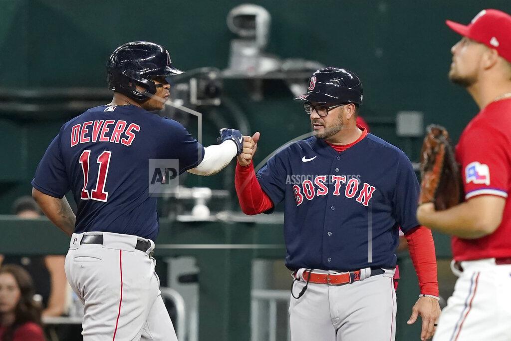 Lm Otero Boston Red Sox's Rafael Devers (11) gets a fist bump from first base coach Ramon Vazquez after hitting an RBI single against the Texas Rangers during the third inning of a baseball game in Arlington, Texas, Friday, May 13, 2022. (AP Photo/LM Otero)