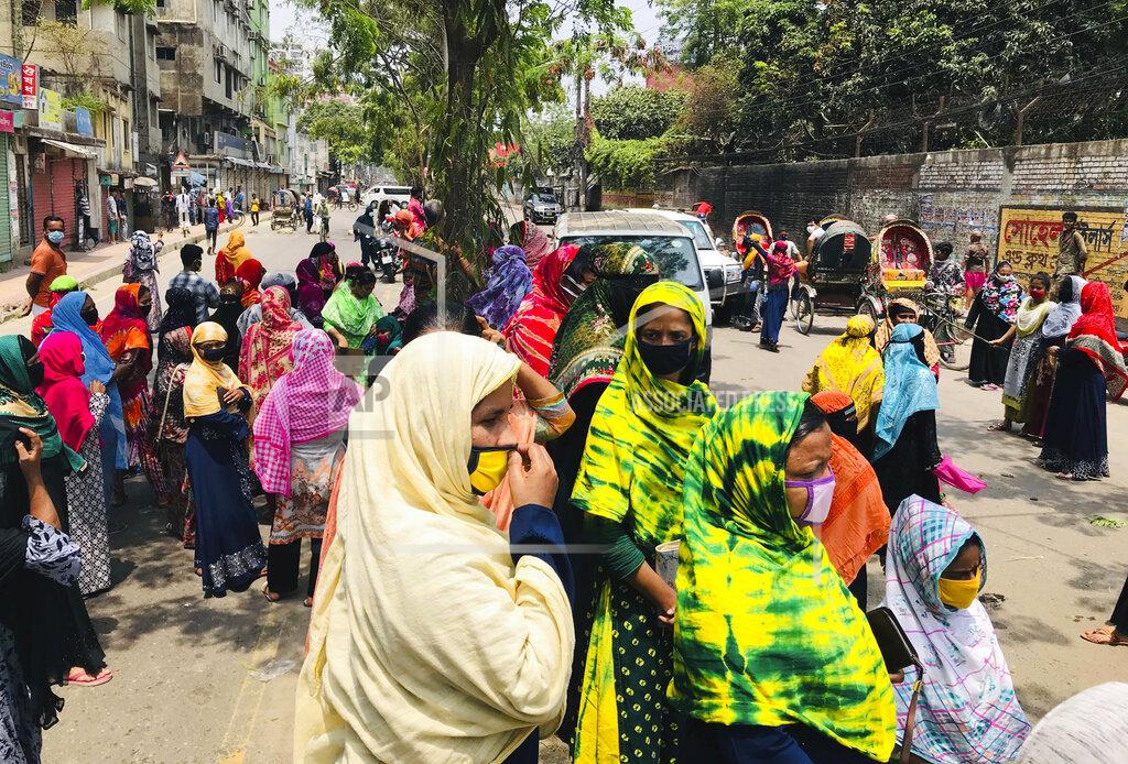 Al-Emrun Garjon Bangladeshi garment workers block a road demanding their unpaid wages during a protest in Dhaka, Bangladesh, Thursday, April 16, 2020. Hundreds of Bangladeshi workers who produce garments for global brands protested in Dhaka and blocked a highway outside the capital on Thursday to demand unpaid wages during a nationwide lockdown that has forced most factories to suspend operations. (AP Photo/Al-emrun Garjon)