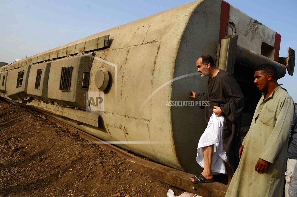 Tarek Wagih People gather at the site where a passenger train derailed injuring at least 100 people, near Banha, Qalyubia province, Egypt, Sunday, April 18, 2021. At least eight train wagons ran off the railway, the provincial governor's office said in a statement. (AP Photo/Tarek Wagih)