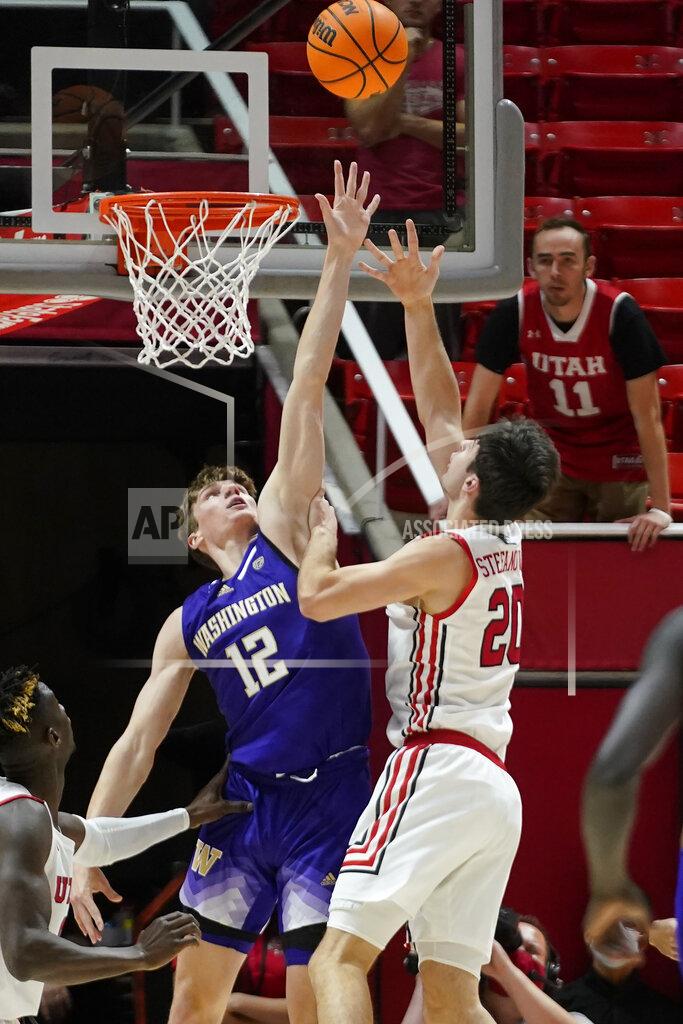 Rick Bowmer Utah guard Lazar Stefanovic (20) shoots as Washington forward Jackson Grant (12) defends during the first half of an NCAA college basketball game Thursday, Jan. 6, 2022, in Salt Lake City. (AP Photo/Rick Bowmer)