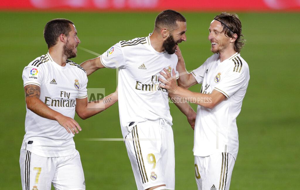 Manu Fernandez Real Madrid's Karim Benzema, center, celebrates with his teammates Eden Hazard, left, and Luka Modric after scoring his side's opening goal during the Spanish La Liga soccer match between Real Madrid and Valencia at Alfredo di Stefano stadium in Madrid, Spain, Thursday, June 18, 2020. (AP Photo/Manu Fernandez)
