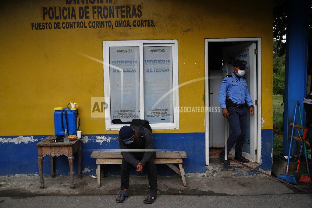 Moises Castillo A Honduran migrant sits at a border police station in Corinto, Honduras, after he turned around and left behind the group of migrants he was traveling with in Guatemala who are heading north the the U.S., Friday, Oct. 2, 2020. Guatemala vowed to detain and return members of a new caravan of about 2,000 migrants that set out from neighboring Honduras in hopes of reaching the United States, saying they represent a health threat amid the coronavirus pandemic. (AP Photo/Moises Castillo)
