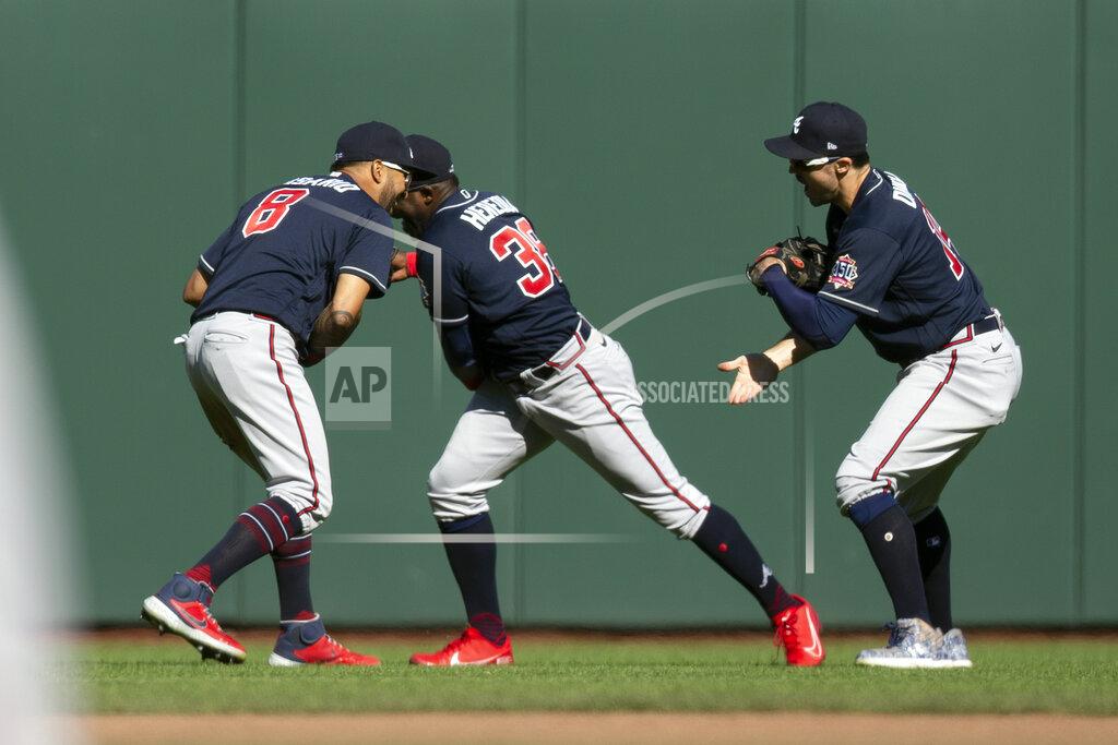 D. Ross Cameron Atlanta Braves outfielders Eddie Rosario (8), Guillermo Heredia (38) and Adam Duvall celebrate their victory over the San Francisco Giants in a baseball game, Sunday, Sept. 19, 2021, in San Francisco. (AP Photo/D. Ross Cameron)