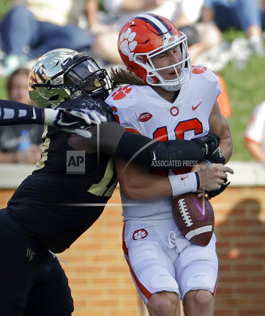 Chuck Burton Clemson's Trevor Lawrence (16) is sacked by Wake Forest's Carlos Basham Jr. (18) during the first half of an NCAA college football game in Charlotte, N.C., Saturday, Oct. 6, 2018. (AP Photo/Chuck Burton)