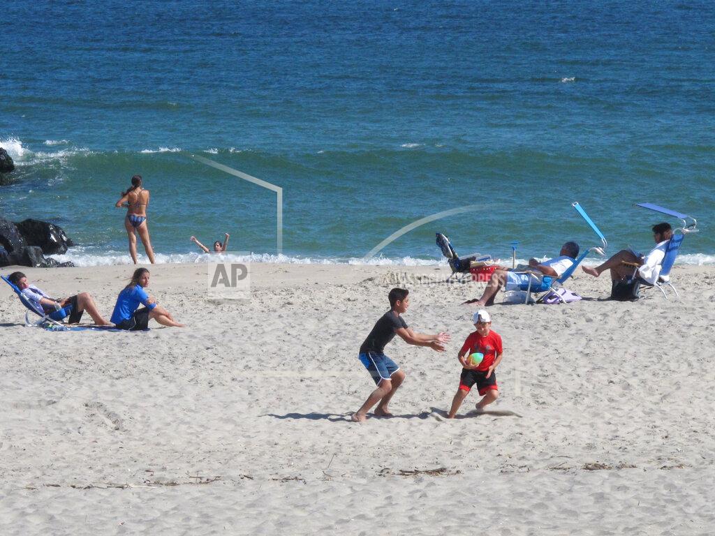 Wayne Parry This Sept. 27, 2021, photo shows people on the beach in Deal, N.J. Deal is one of three Jersey Shore towns that will share a $26 million beach replenishment project starting in November. (AP Photo/Wayne Parry)