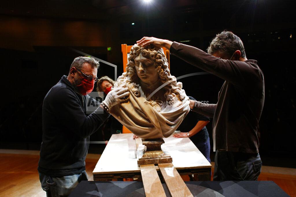 Thibault Camus Workers handle a bust of Charles Le Brun by French sculptor Antoine Coysevox, in the Louvre museum, in Paris, Wednesday, Feb. 17, 2021. It's uncertain when the Louvre will reopen, after being closed on Oct. 30 in line with the French government's virus containment measures. But those lucky enough to get in benefit from a rarified private look of collections covering 9,000 years of human history -- with plenty of space to breathe. (AP Photo/Thibault Camus)