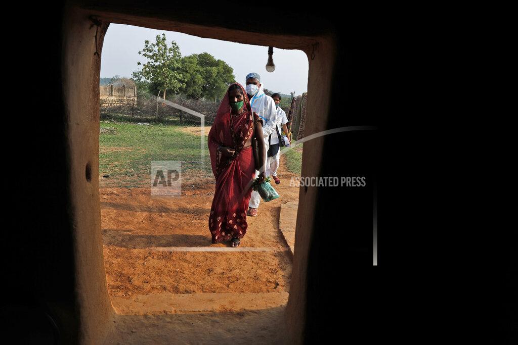 Rajesh Kumar Singh Health workers arrive at a house during a vaccination drive against COVID-19 in Jamsoti village, Uttar Pradesh state, India, on June 8, 2021. India's vaccination efforts are being undermined by widespread hesitancy and fear of the jabs, fueled by misinformation and mistrust. That's especially true in rural India, where two-thirds of the country’s nearly 1.4 billion people live. (AP Photo/Rajesh Kumar Singh)