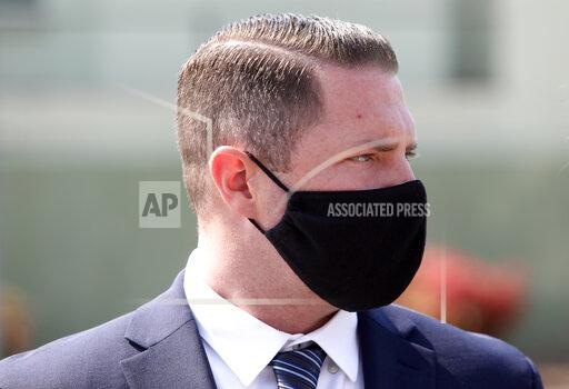 FILE - In this Oct. 4, 2021, file photo, Danville Police Officer Andrew Hall stands on Court Street after leaving the A.F. Bray Courts Building in Martinez, Calif. The California police officer was convicted Tuesday, Oct. 26, 2021, of assault with a firearm in the 2018 fatal shooting of an unarmed, mentally ill man in a wealthy San Francisco suburb. (Lea Suzuki/San Francisco Chronicle via AP, File)