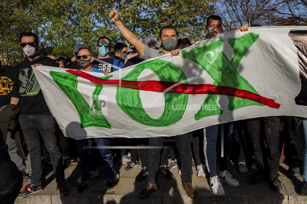 Bernat Armangue Left-wing protesters gather against a campaign event of the far-right Vox party in Madrid, Spain, Wednesday, April 7, 2021. Spanish police had to use batons on Wednesday to keep protesters away from supporters of the far-right Vox party at a campaign rally in Madrid. Scuffles started when the national leader of Vox, Santiago Abascal, approached a crowd which had gathered to protest the party rally in Madrid's working-class Vallecas neighborhood, a traditional left-wing bastion. Riot peace charged several hundred protesters to keep them away from Abascal and other members of his party campaigning for May 4 regional elections in the area including Spain's capital. (AP Photo/Bernat Armangue)