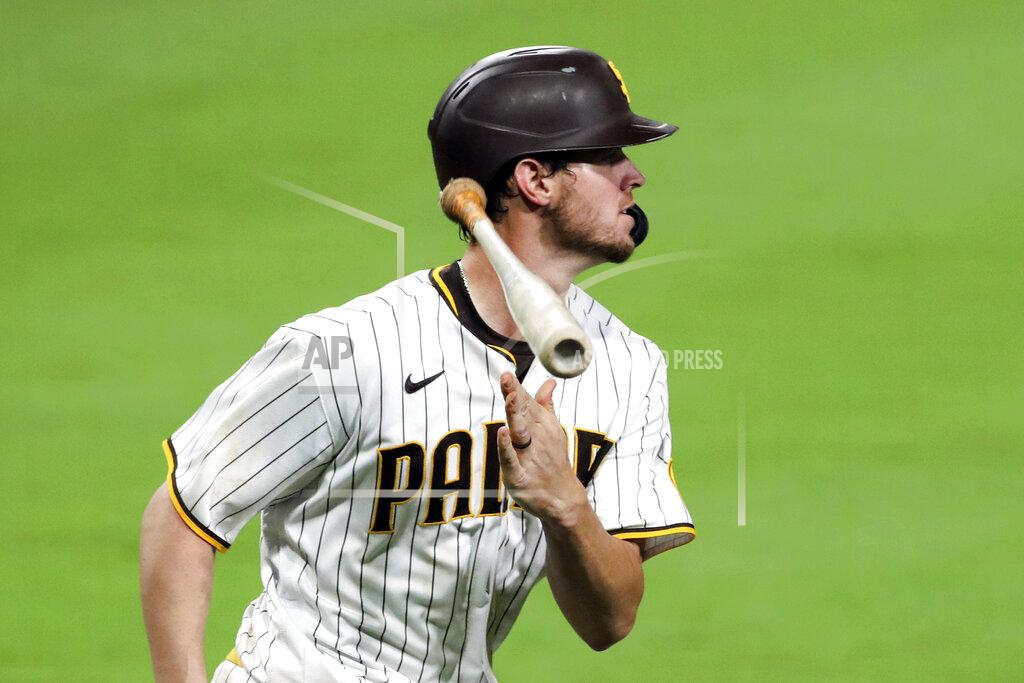 FILE - In this Sept. 14, 2020 file photo, San Diego Padres' Wil Myers flips his bat after hitting a solo home run off Los Angeles Dodgers relief pitcher Josh Sborz in the eight inning of a baseball game in San Diego. While Manny Machado and Fernando Tatis Jr. have grabbed most of the attention on the playoff-bound Padres, Myers' comeback performance has also been instrumental in returning San Diego to postseason play for the first time since 2006. Myers is hitting .291 with 14 homers and 38 RBIs in 52 games. (AP Photo/Derrick Tuskan, File)