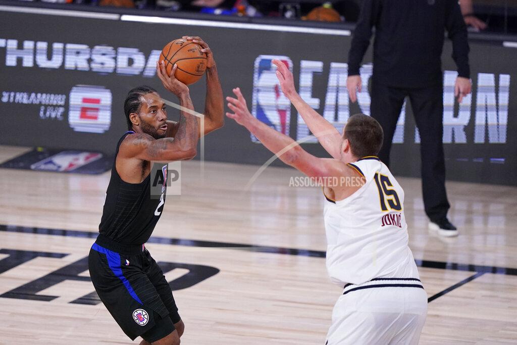 Mark J. Terrill Los Angeles Clippers forward Kawhi Leonard (2) shoots over Denver Nuggets center Nikola Jokic (15) during the second half of an NBA conference semifinal playoff basketball game Tuesday, Sept. 15, 2020, in Lake Buena Vista, Fla. (AP Photo/Mark J. Terrill)