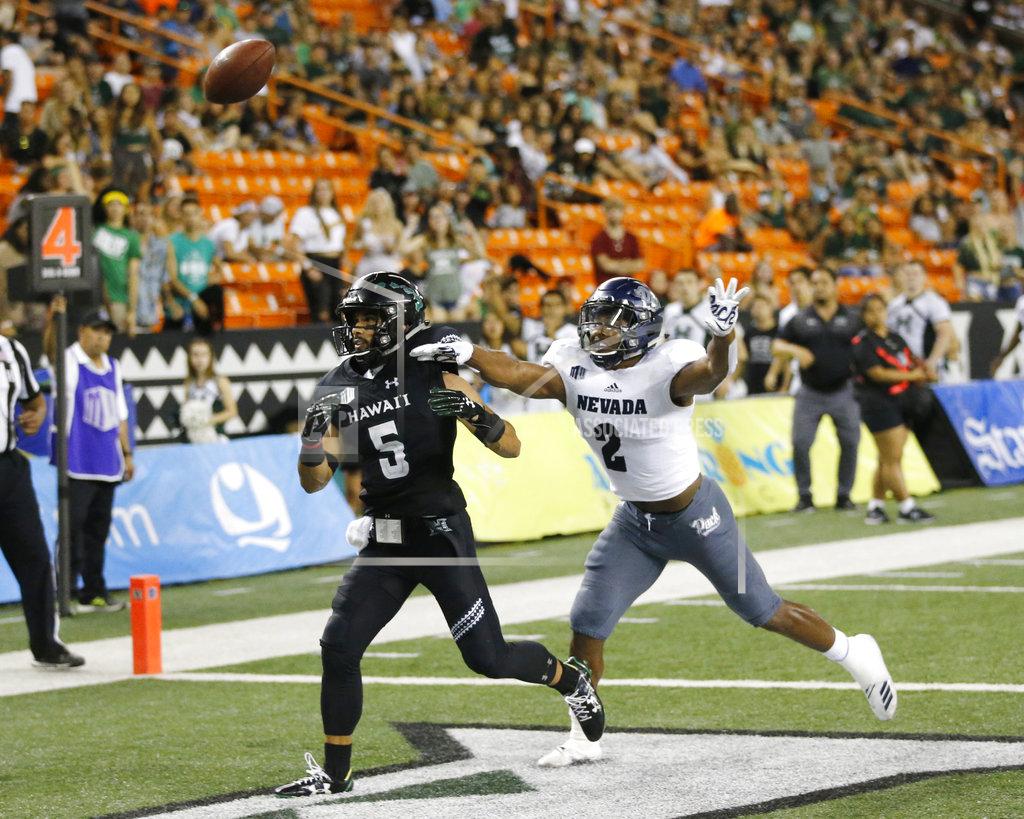 Marco Garcia While being guarded by Nevada defensive back Asauni Rufus (2), Hawaii wide receiver John Ursua (5) can't catch an overthrown pass in the end zone during the third quarter at an NCAA college football game Saturday, Oct. 20, 2018, in Honolulu. (AP Photo/Marco Garcia)