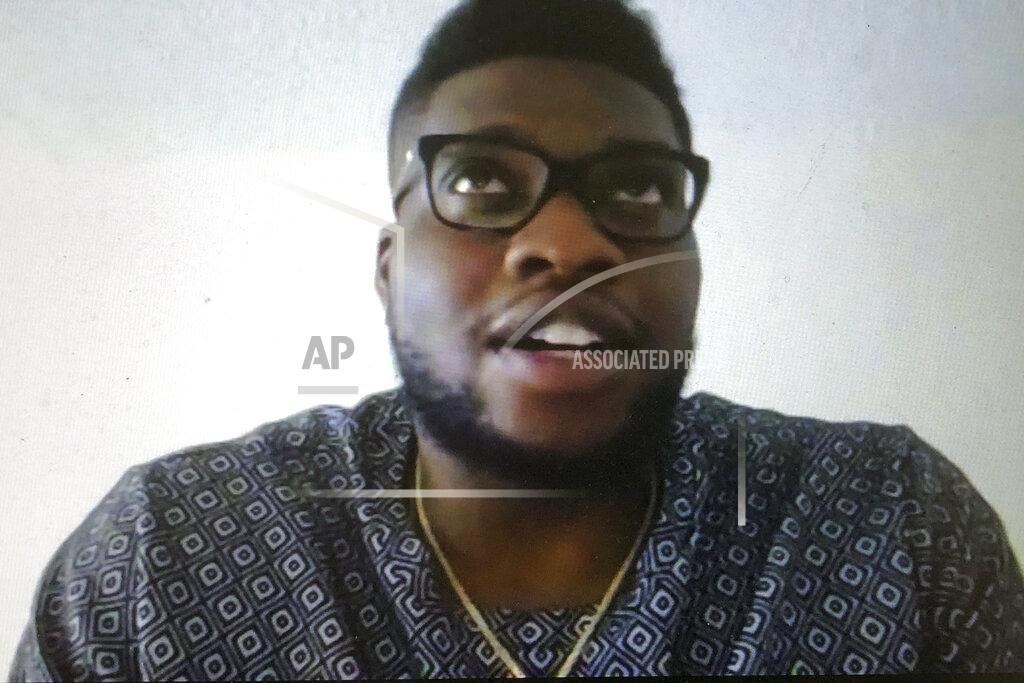 Steve Wine Miami Dolphins NFL football player Emmanuel Ogbah is shown during a Zoom news conference in this photo made in Miami Lakes, Fla., Thursday, March 26, 2020. The Miami Dolphins practiced safe distancing when they introduced eight newly acquired players hunkered down around the country, holding a series of news conferences via Zoom. The technology changed the dynamics of the conversation, and players seemed to like it. (AP Photo/Steve Wine)