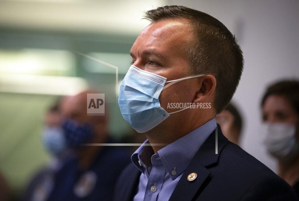 Illinois State Sen. Andy Manar, D-Bunker Hill, listens as Illinois Governor JB Pritzker unveils a new mask awareness campaign called "It Only Works If You Wear It" during a press conference at the IEMA State Emergency Operations Center, Monday, August 3, 2020, in Springfield, Ill. (Justin L. Fowler/The State Journal-Register via AP)